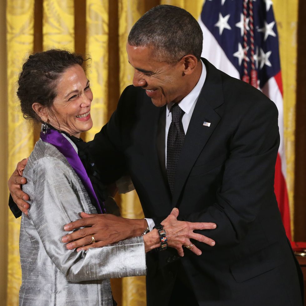 julia alvarez smiling as she hugs president barack obama
