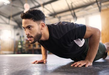 fitness, training and push up with man in gym for training, muscle and workout endurance determination, strong and power with bodybuilder and floor exercise for sports, wellness and athlete