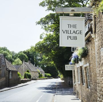 exterior view of village pub with sign advertising available rooms