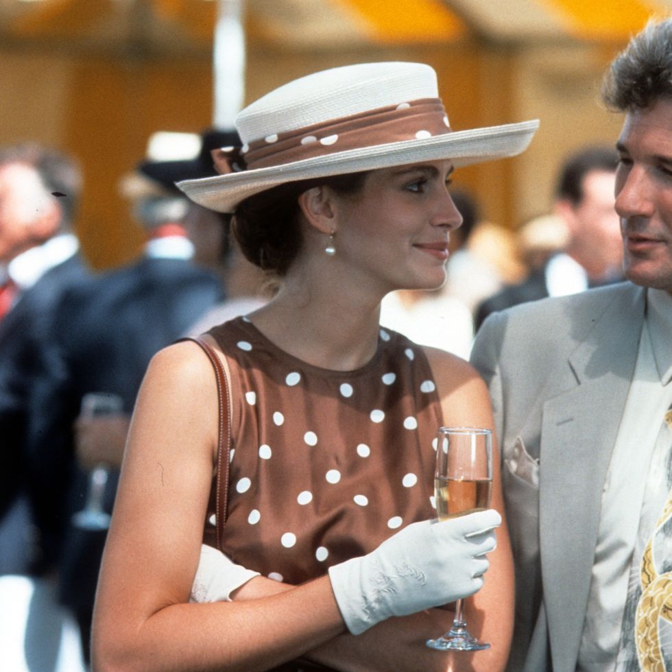 a scene from pretty woman where julia roberts' vivian is at a polo match wearing a brown and white polka dot dress