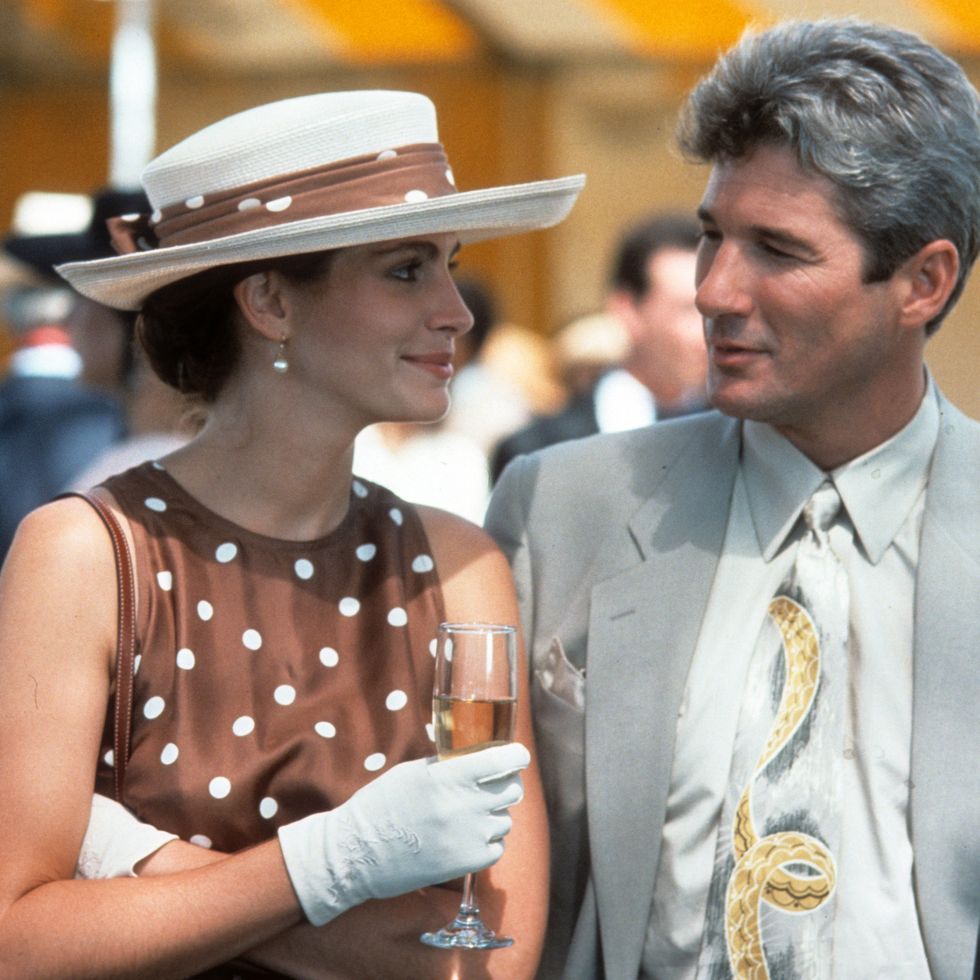 a scene from pretty woman where julia roberts' vivian is at a polo match wearing a brown and white polka dot dress