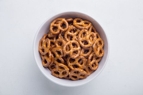 directly above shot of pretzels in bowl on white background