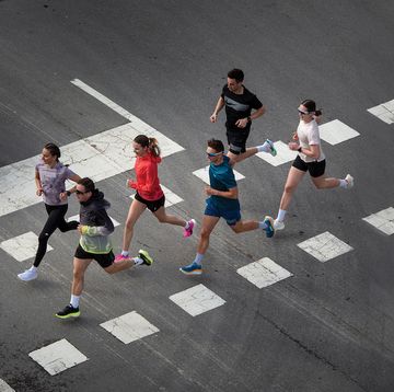 a group of people running on a street