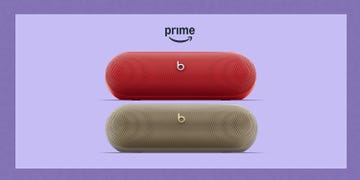 two portable bluetooth speakers in red and beige with prime text above
