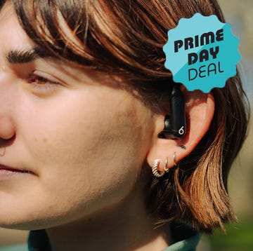 wireless earbuds in a charging case held in hands wireless earbuds in a charging case held in hands