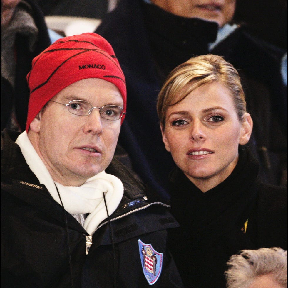 prince albert of monaco with his new girlfriend charlene wittstock at the opening ceremony of the 2006 winter olympics in turin, italy on february 10, 2006
