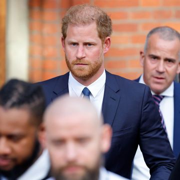 prince harry walking into london high court with escorts
