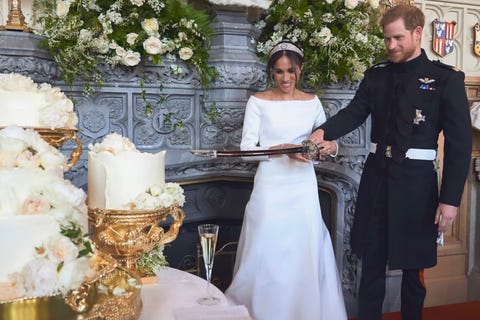 prince harry and meghan markle cutting the cake at their wedding