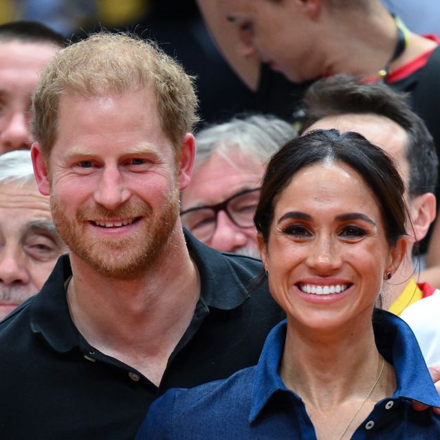 prince harry puts arm around meghan markle at sport event