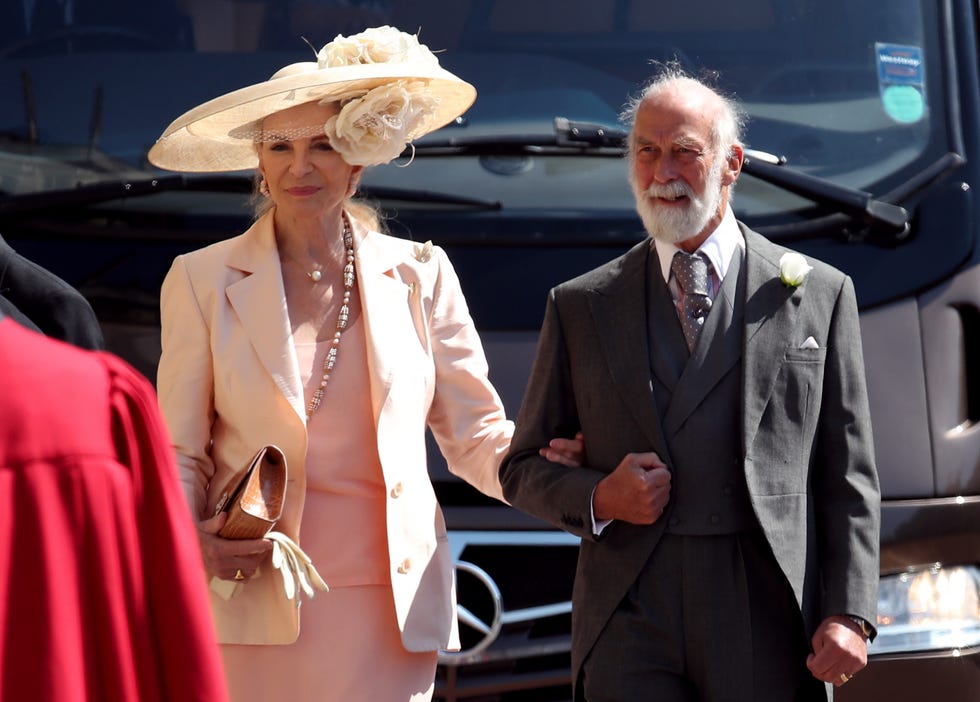 Fashion, Suit, Luxury vehicle, Formal wear, Dress, Event, Headgear, Hat, Vehicle, Car, 