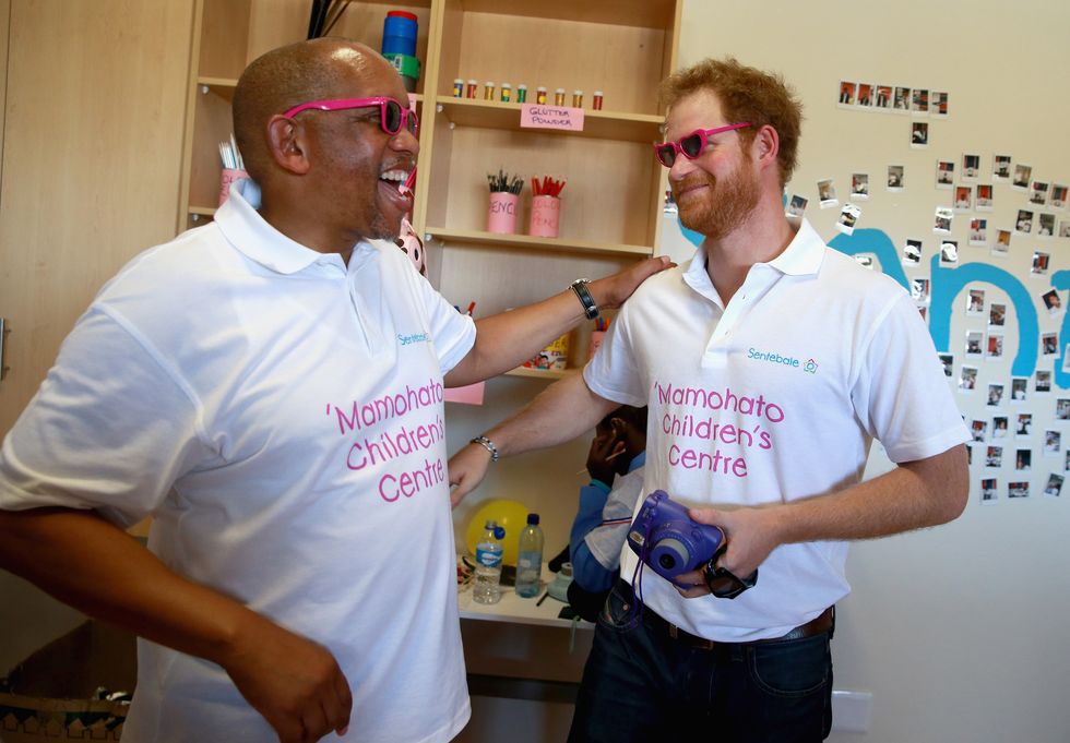 Prince Harry takes a photograph of Prince Seeiso during a photography activity at the Mamohato Children's Centre on October 17, 2015 in Maseru, Lesotho.