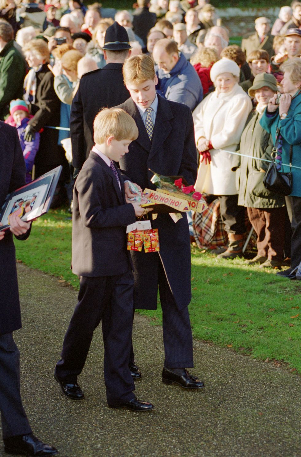 prince william and prince harry hold gifts given to them by
