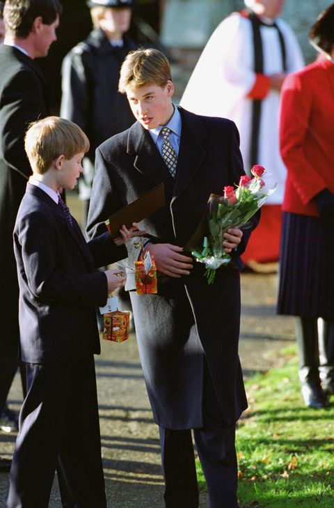 prince william and prince harry holding gifts given to them