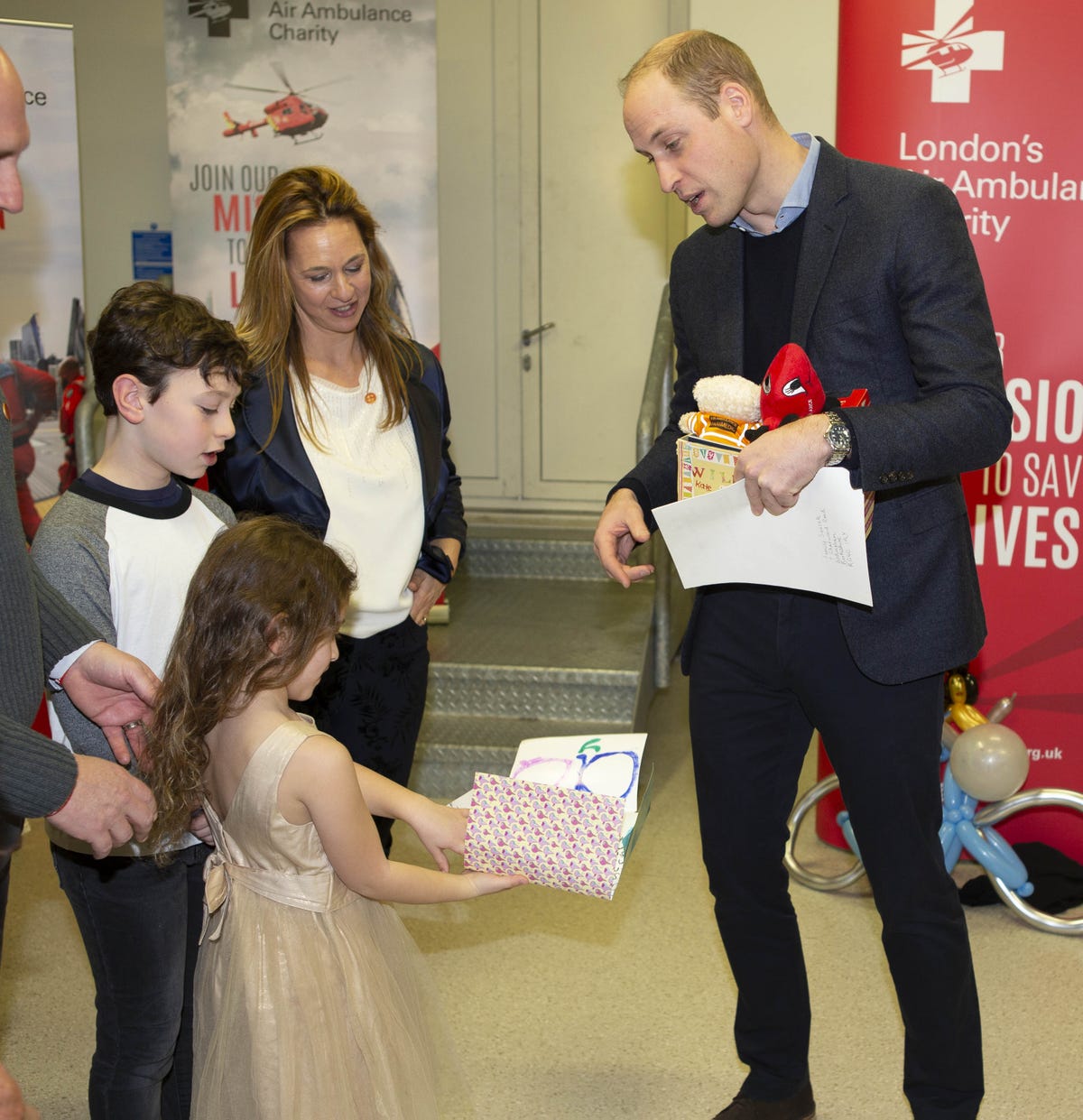 Prince William Accepts Prince George's Gift, a Toy Helicopter, from  London's Air Ambulance Charity