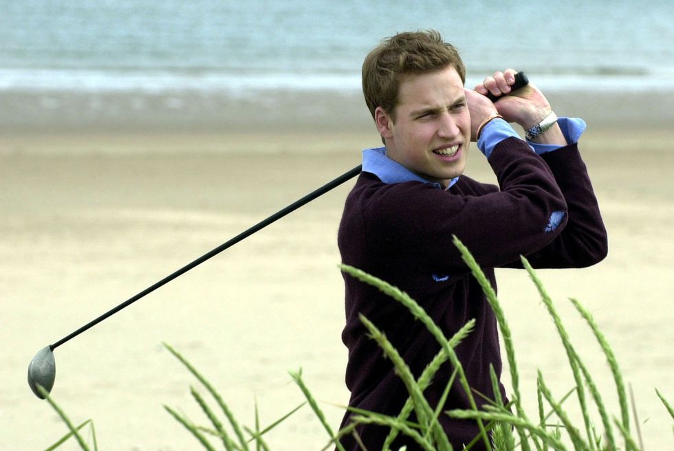 prince william practises his golf swing