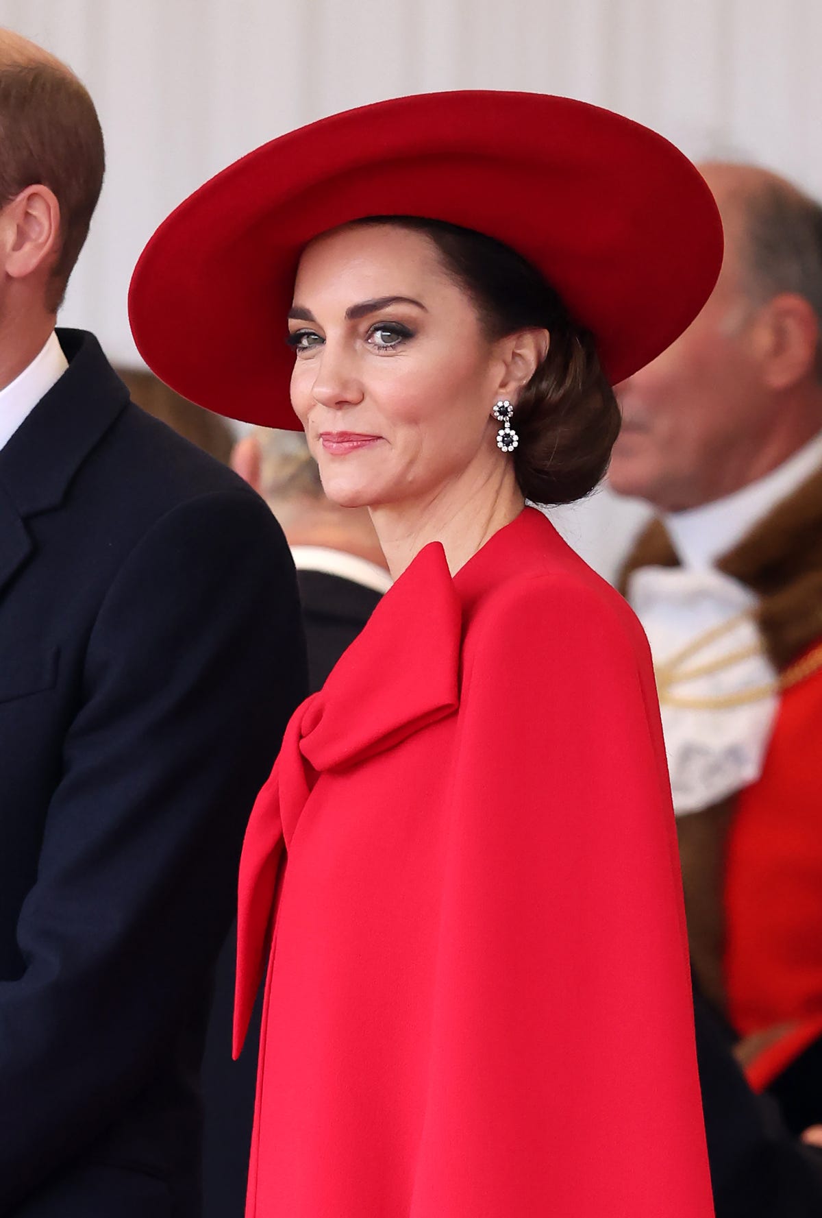 Kate Middleton Revives Royal Glamour in a Candy-Apple Red Cape Dress