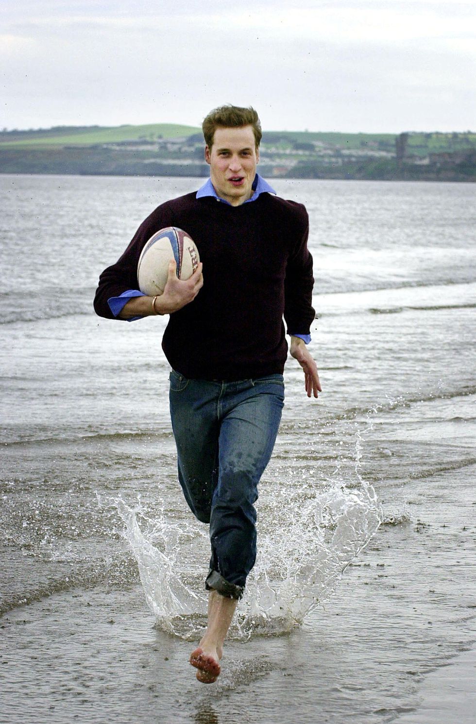 prince william runs with a rugby ball on