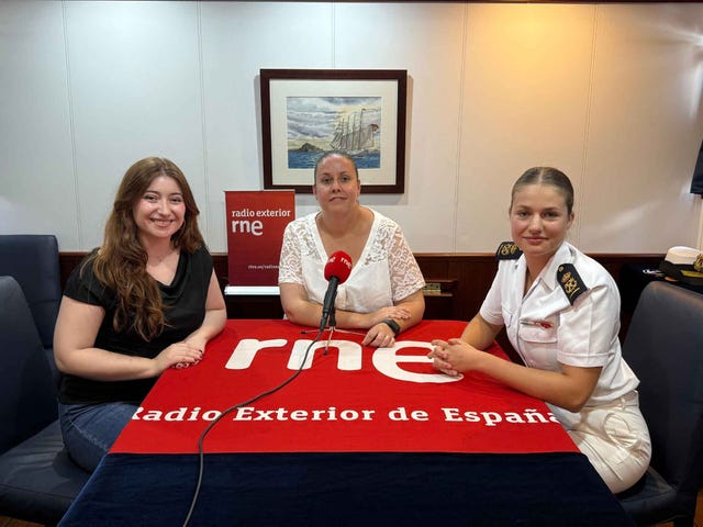 discussion at a radio station with guests and hosts seated at a table