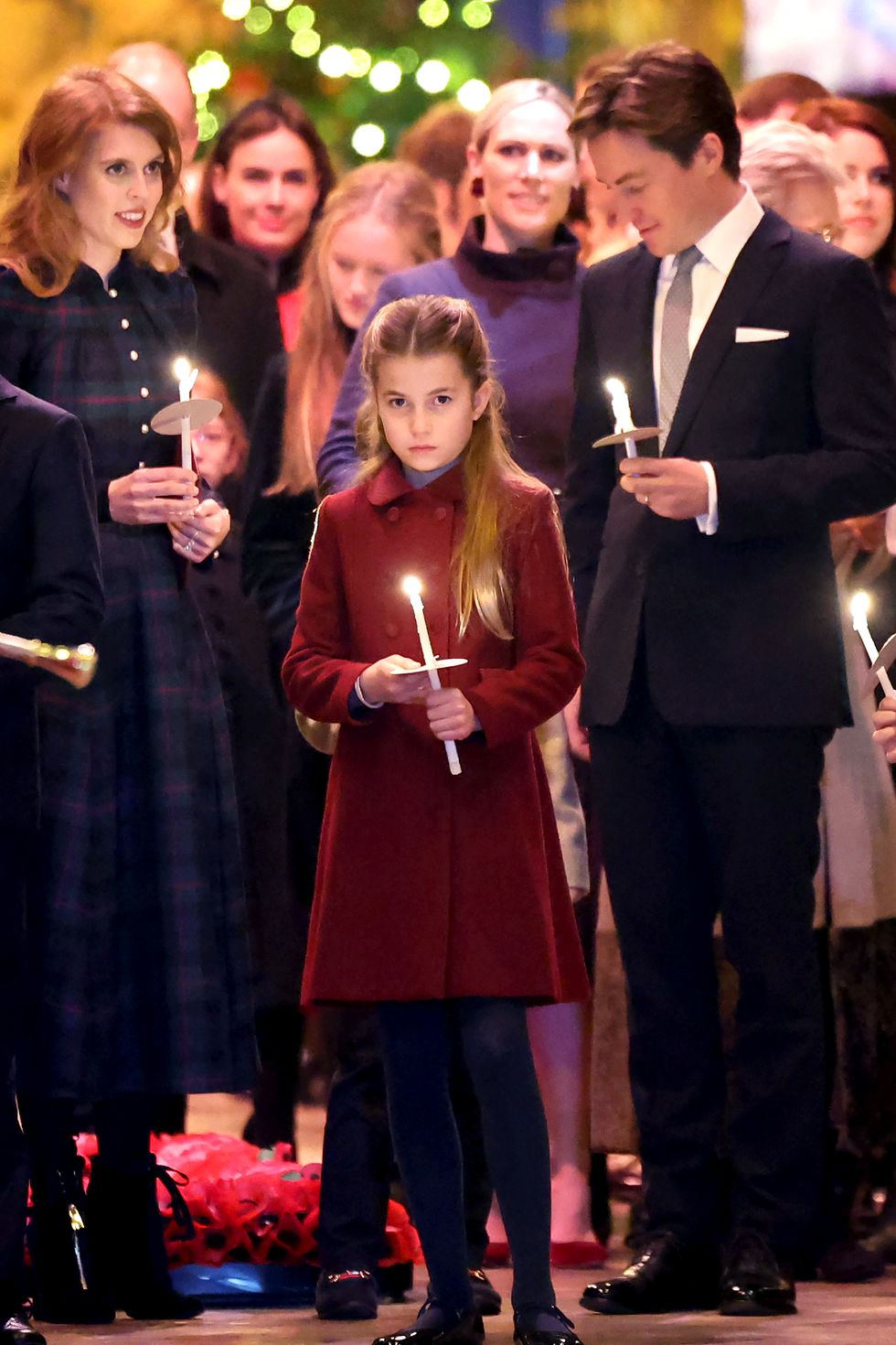 princess charlotte of wales holds a candle as she leaves with her family at the "together at christmas" carol service