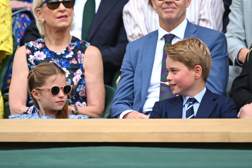 princess charlotte of wales and prince george of wales watch carlos alcaraz vs novak djokovic in the wimbledon 2023 mens final on centre court, both sat in the royal box, charlotte with sunglasses on and a floral blue dress and george in a suit