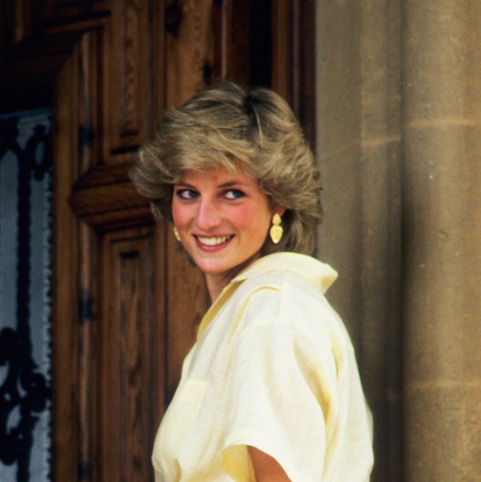 princess diana smiling wearing yellow jumpsuit while on holiday in majorca, 1987