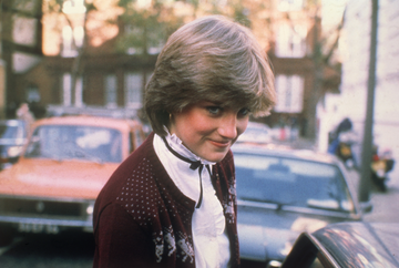 lady diana spencer wearing a maroon cardigan, white shirt and black bow before she officially became princess diana