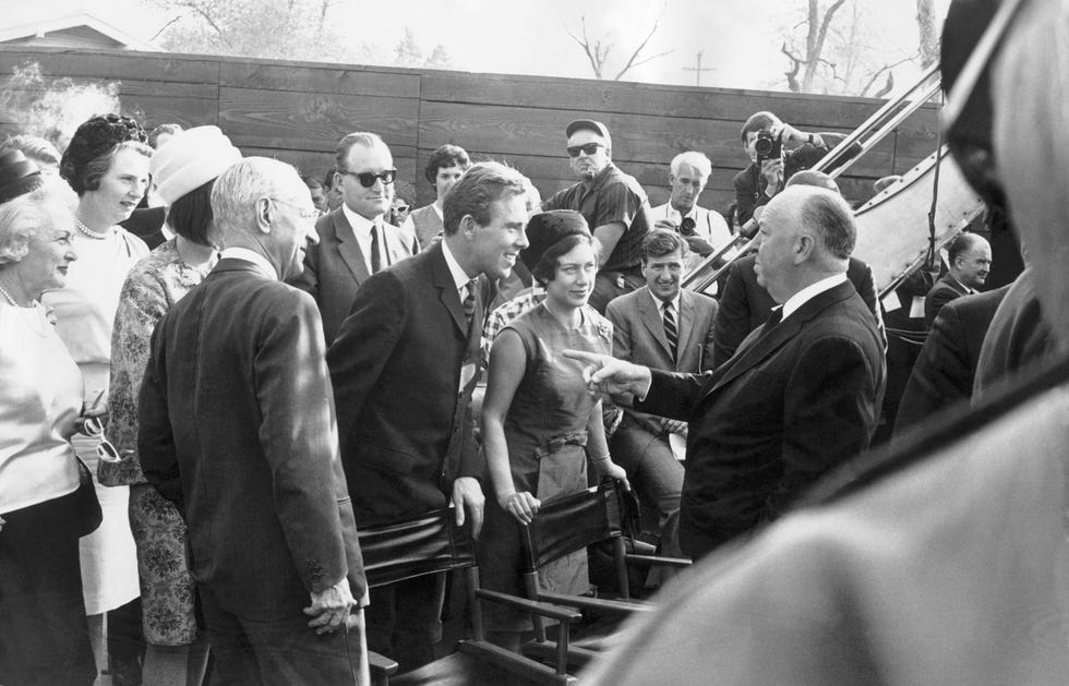 princess margaret and lord snowdon talking with alfred hitchcock in hollywood in 1965