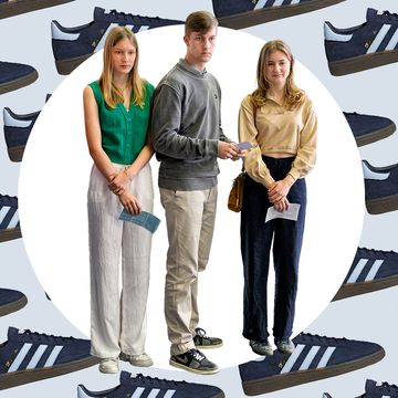 a group of people standing in front of a wall of shoes