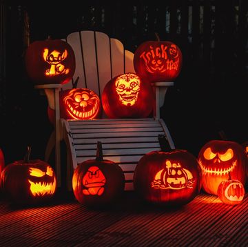 group of illuminated pumpkins in the dark
