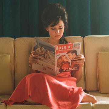 a person sitting on a couch reading a book