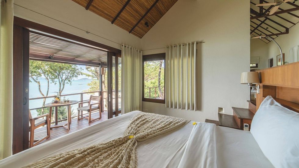 a bedroom with a large window at kamalay in thailand