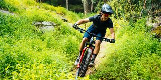 male mountain biker riding trail