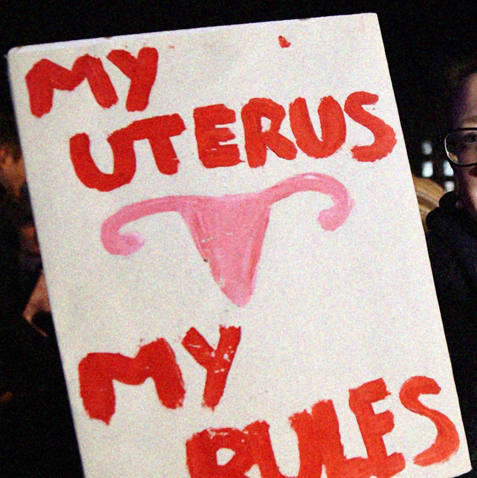 a sign with red text saying my uterus my rules