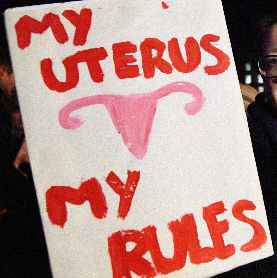 a sign with red text saying my uterus my rules