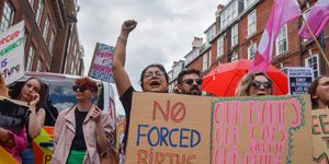 a pro choice protester holds a placard which states 'no