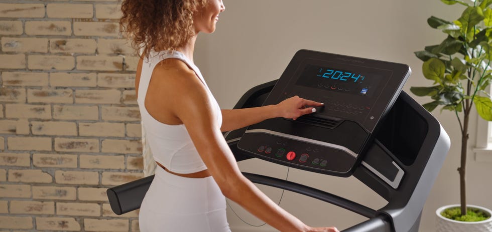 user interacting with a treadmill console