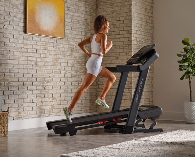 person running on a treadmill in a modern room