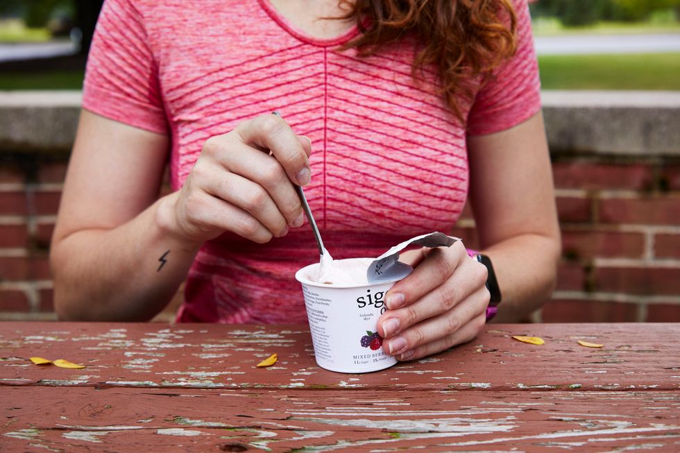 a woman eating yogurt