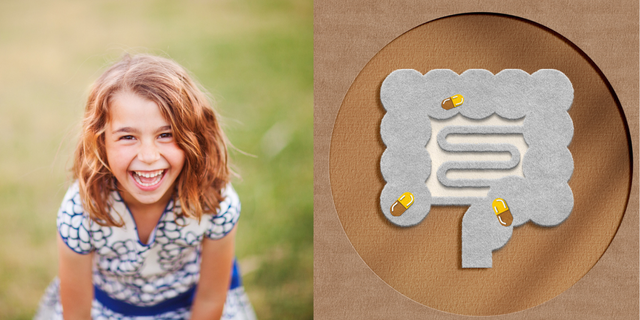 a girl smiling next to a sign