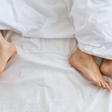 problems in family relationship feet of man and woman in white bed at distance