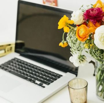 laptop and vase of flowers