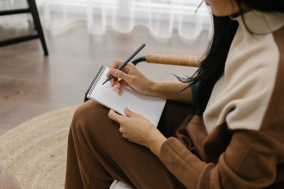woman writing in a journal