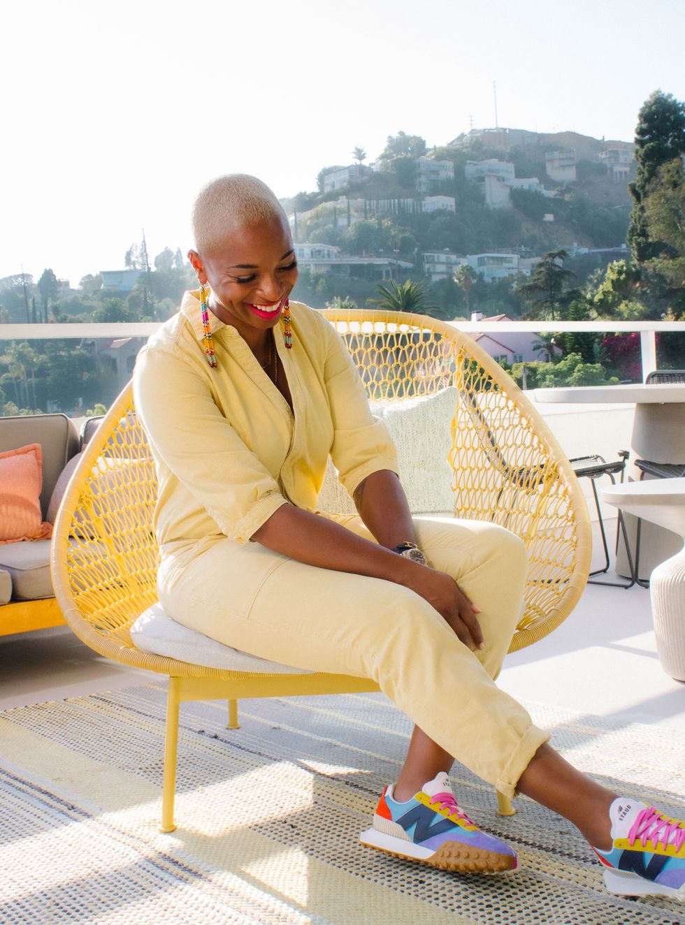 crystal vinisse thomas sitting on a yellow chair