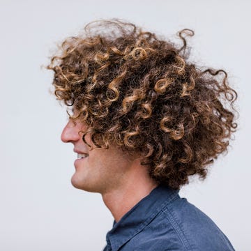 profile of smiling man with curly hair