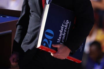 a man holds a large book