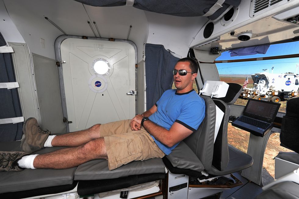 project engineer aaron hulse checks out the sleeping bunk inside the rover during an earlier period of testing in 2010