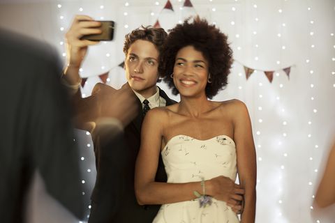 couple taking a selfie at prom party