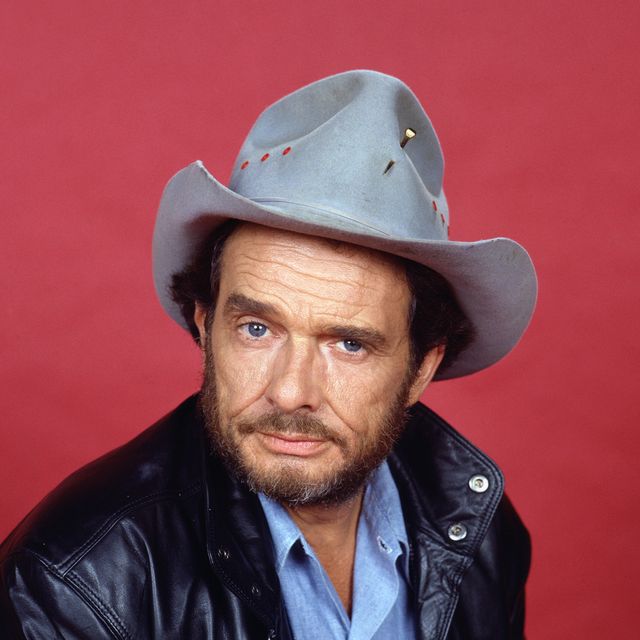 portrait of a younger merle haggard wearing cowboy hat and black leather jacket