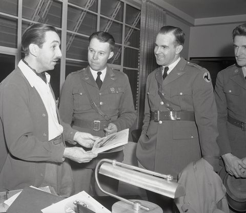 walt disney discussing insignia with air corps officer