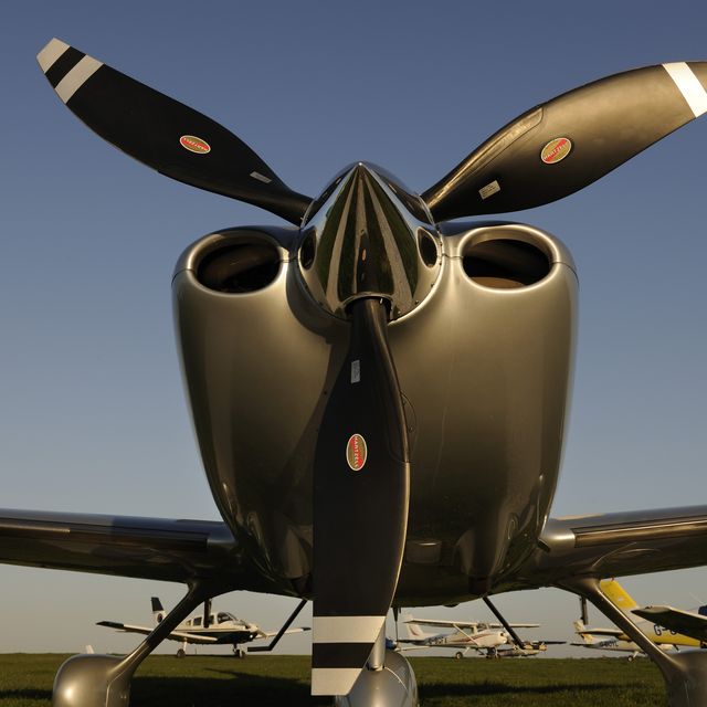 Propellers of Cirrus SR-22 with Synergy Aviation Piper PA-28 Cherokees and Cessna 152s parked behind